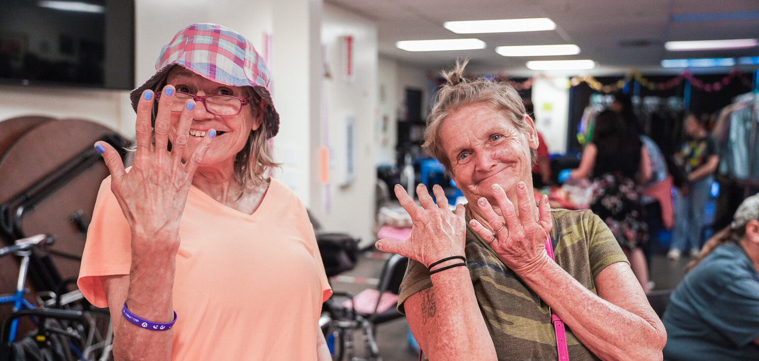 Two guests show off their new bling at the birthday.