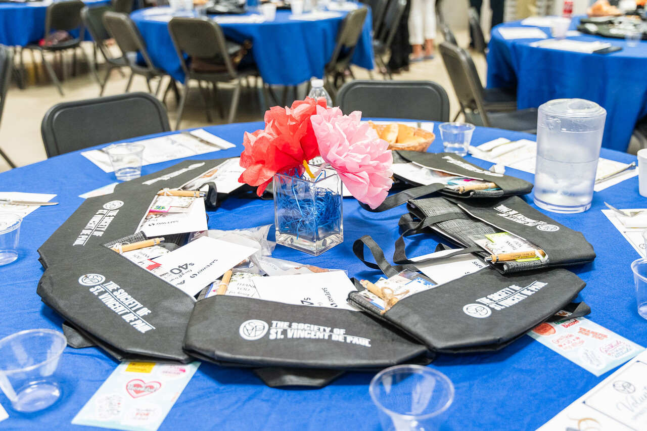 The table setting at the luncheon waits for its volunteers to collect them.