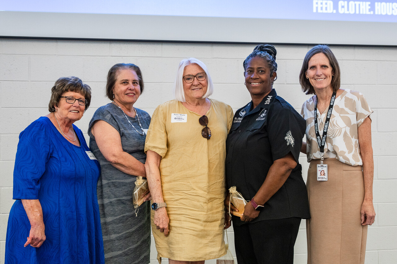Shirley Smalley, board president, and Shannon Clancy, CEO, stand with volunteers who received awards at the luncheon.