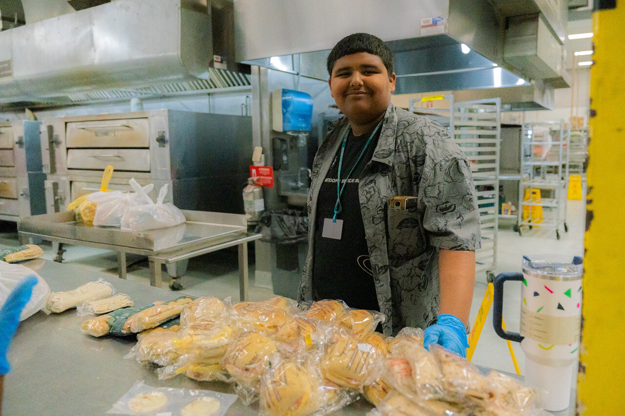 Jason helps sort food donations before they go out to guests at SVdP's Family Evening Meal.
